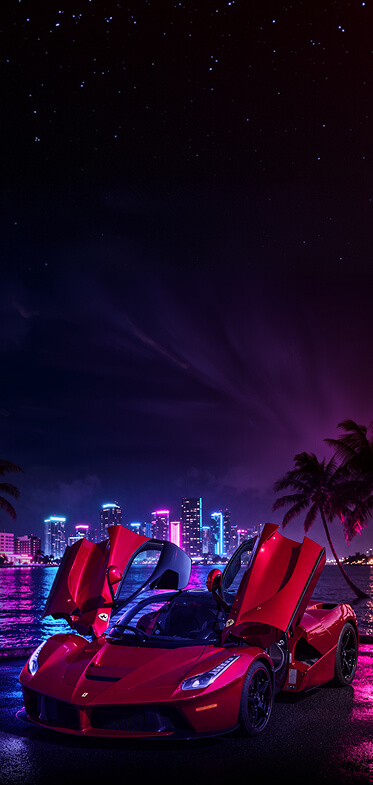Red Ferrari with butterfly doors open parked by a neon-lit waterfront at night, city skyline in background